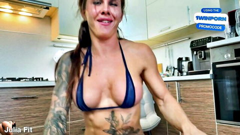 Julia Fit tattooed muscular babe in tiny blue micro bikini teasing