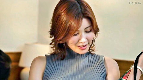 Smiling Asian redhead babe in tight gray ribbed tank top showing cleavage