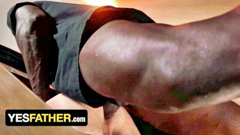 Muscular black man in shorts, provocative bottom pose for gay confession scene