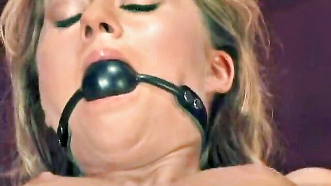 Blonde woman with ball gag in BDSM machine orgasm scene