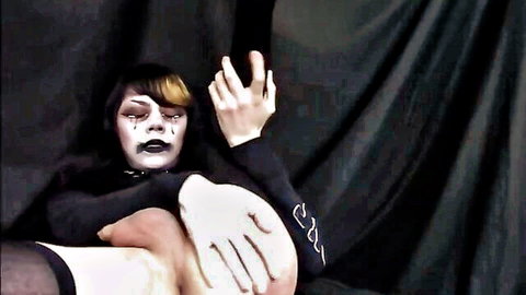 Goth trans babe with heavy black makeup and stockings has rough hand gripping her pale thigh seductively