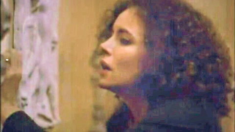 Curly haired Caucasian woman with open mouth moaning in pleasure closeup