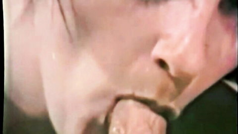 Vintage closeup of brunette with thick cock head on her extended tongue in mouth