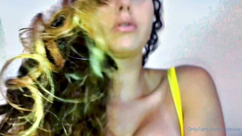 Jessie Rogers in yellow lingerie, blonde curls and deep cleavage tease