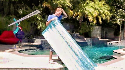 Tattooed blonde guy holding pool float in Mylf MILF cowgirl scene teaser