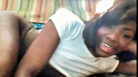 Ebony woman in white tee masturbating solo on bed