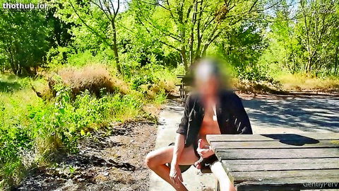 Nude babe with big tits spreads shaved pussy and fucks it with dildo outdoors on picnic table