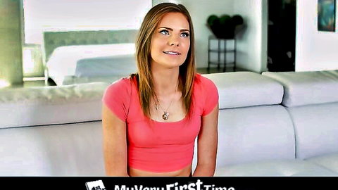 Petite teen babe with small tits smiling in tight pink My First Time crop top on couch