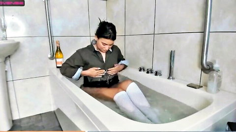 Amateur e-girl exposes wet tits in bathtub wearing knee socks holds phone
