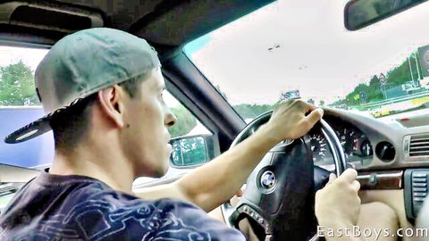 Young man driving BMW on scenic highway, EastBoys gay solo tease