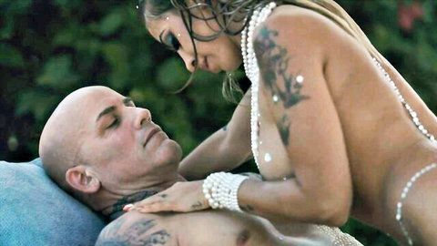 Marika Milani topless with tattoos straddling bald stud in outdoor anal scene