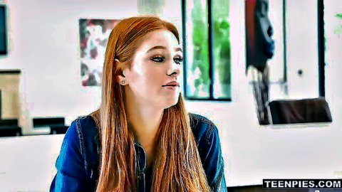 Stunning blue-eyed ginger with long red hair in denim jacket