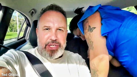 Tattooed Latina BBW in blue top with bearded man in car selfie