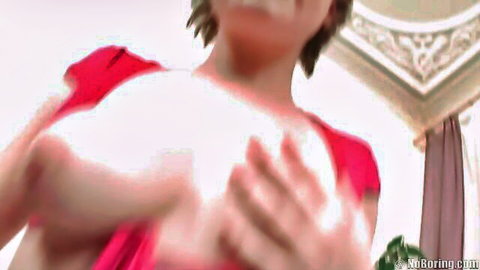 Redhead squeezing her large pale breasts in pulled-down red top