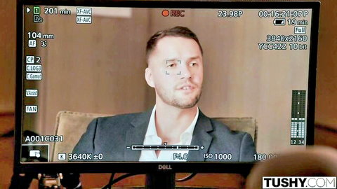 Handsome suited man smirks at camera during TushyRaw video recording session
