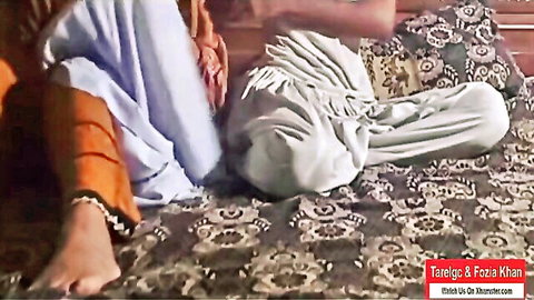 Pakistani wife Taleem Fozia Khan teasing on bed in orange shalwar and white dupatta