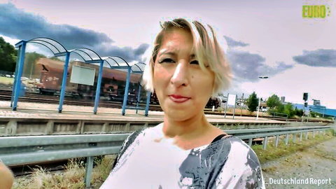 Oda Amelie German MILF posing outdoors in casual top at train station