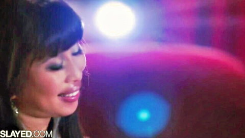 Shy Asian beauty Jade smiles seductively in pink-lit scene from Naughty Nicole video