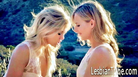 Two blonde women in white lace dresses close in nature, lesbian vibe