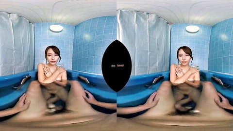 Slim Asian woman nude in bathtub with hands teasing her thighs