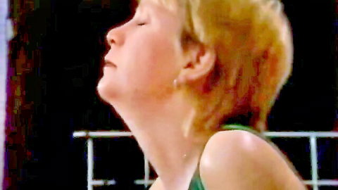 Blonde teen in green tank top, ecstatic face in classic xxx video