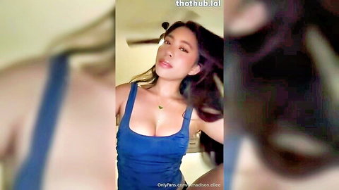 Madison Elle teasing with cleavage in blue dress on OnlyFans