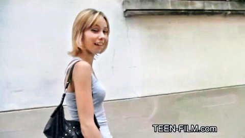 Smiling blonde teen in gray tank top and bag, posh street vibe