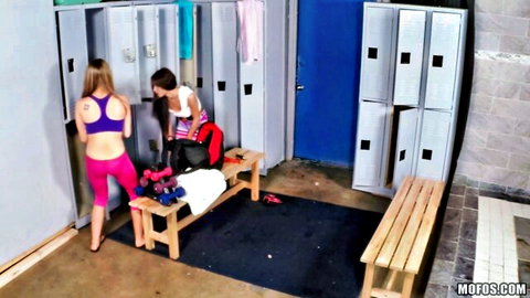 Two fit lesbians caught in intimate locker room moment