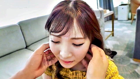 Seductive Asian woman with long hair, hands caressing her neck intimately