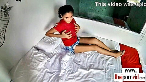 Petite Thai teen Noom cups her big boobs in amateur tease