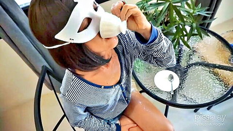 Stunning Asian girl in mask sips cum-laced coffee in pee play fetish scene