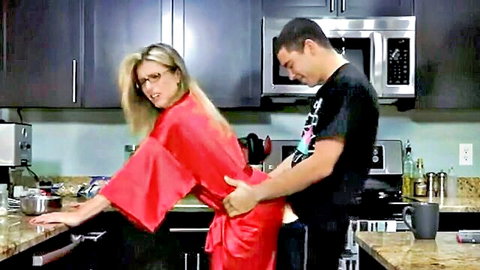 Blonde stepmom in red robe caught bending over by stepson in kitchen
