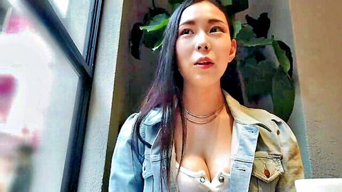 Asian beauty in open denim jacket showing deep cleavage