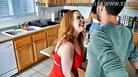 Summer Hart in red dress laughs with Nade Nasty and Willow in steamy kitchen scene