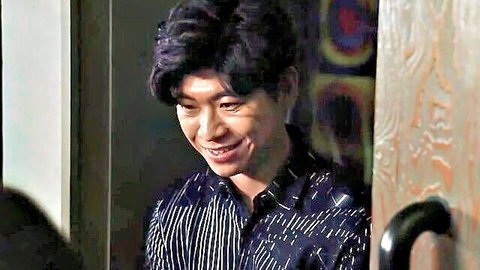 Handsome Asian man smiling in doorway, black hair, striped shirt
