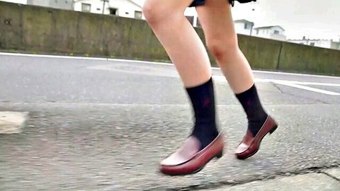 Japanese schoolgirl running in uniform with black stockings and loafers