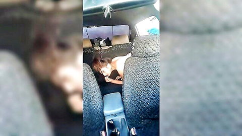 Uzbek woman lying face down in car backseat, black top, intimate rest
