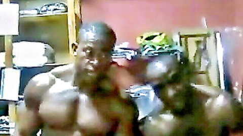 Two muscular ebony men shirtless posing together in amateur homemade bedroom scene