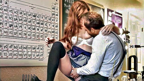 Abbey Rain as sexy redhead nerd in lingerie and stockings kissing on lap