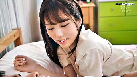 Rima Arai teasing with open shirt on bed, smiling seductively