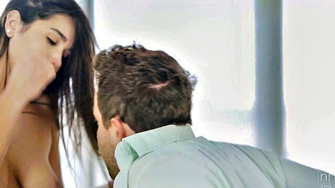 Brunette with huge tits topless kissing man's neck passionately