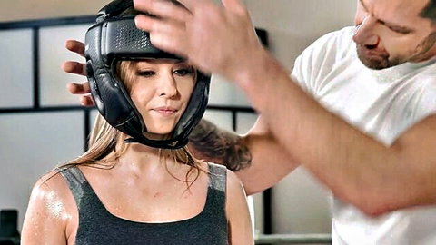 Rebecca Volpetti in wet tank top, trainer adjusts boxing helmet seductively