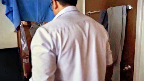 Filipino man in white shirt stands in bathroom mirror reflection partially covered by clear sheet