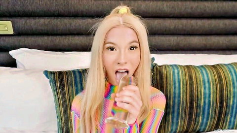 Blonde babe in colorful top licks clear glass dildo with tongue out teasing blowjob
