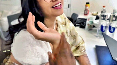 Smiling Indian woman in gold saree groped by black man's hand on her chest