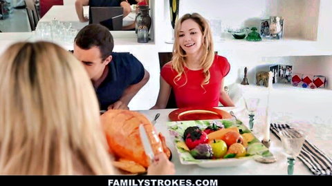 Blonde in red dress smiles at Thanksgiving dinner table with turkey, fruits, and stepfamily.