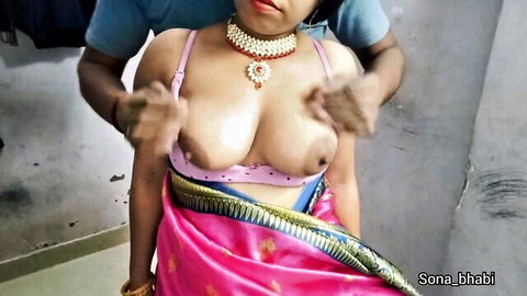 Man gropes and squeezes busty Indian bhabhi's exposed big tits in pink saree