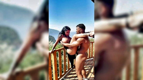 Topless busty brunette in thong gets tits groped by nude muscular BBC stud on mountain deck