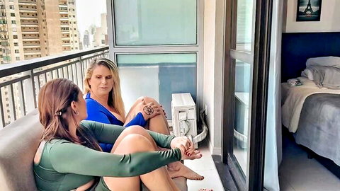 Tiffany Montavani and Agatha Mama in tight outfits teasing on OnlyFans balcony