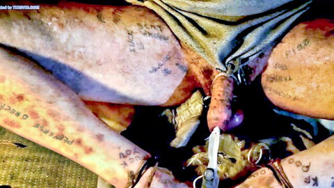 Tattooed man's erect cock exposed between dirty spread legs with nasty tattoos like fuck toy piss god